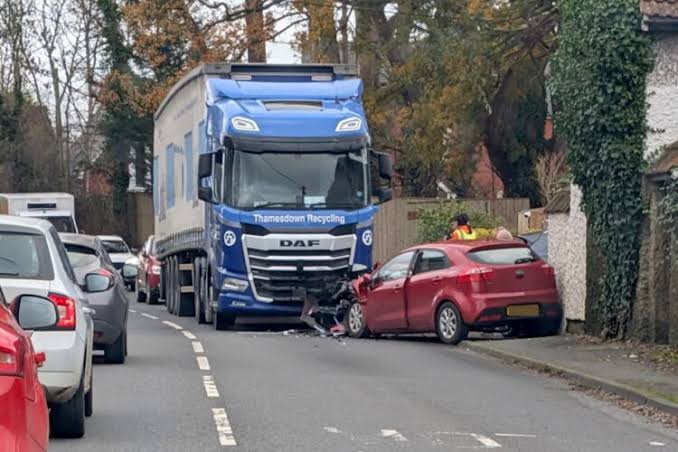HGV Lorry Accident Solicitors involved in a head-on road traffic collision with a red hatchback car on a narrow UK road